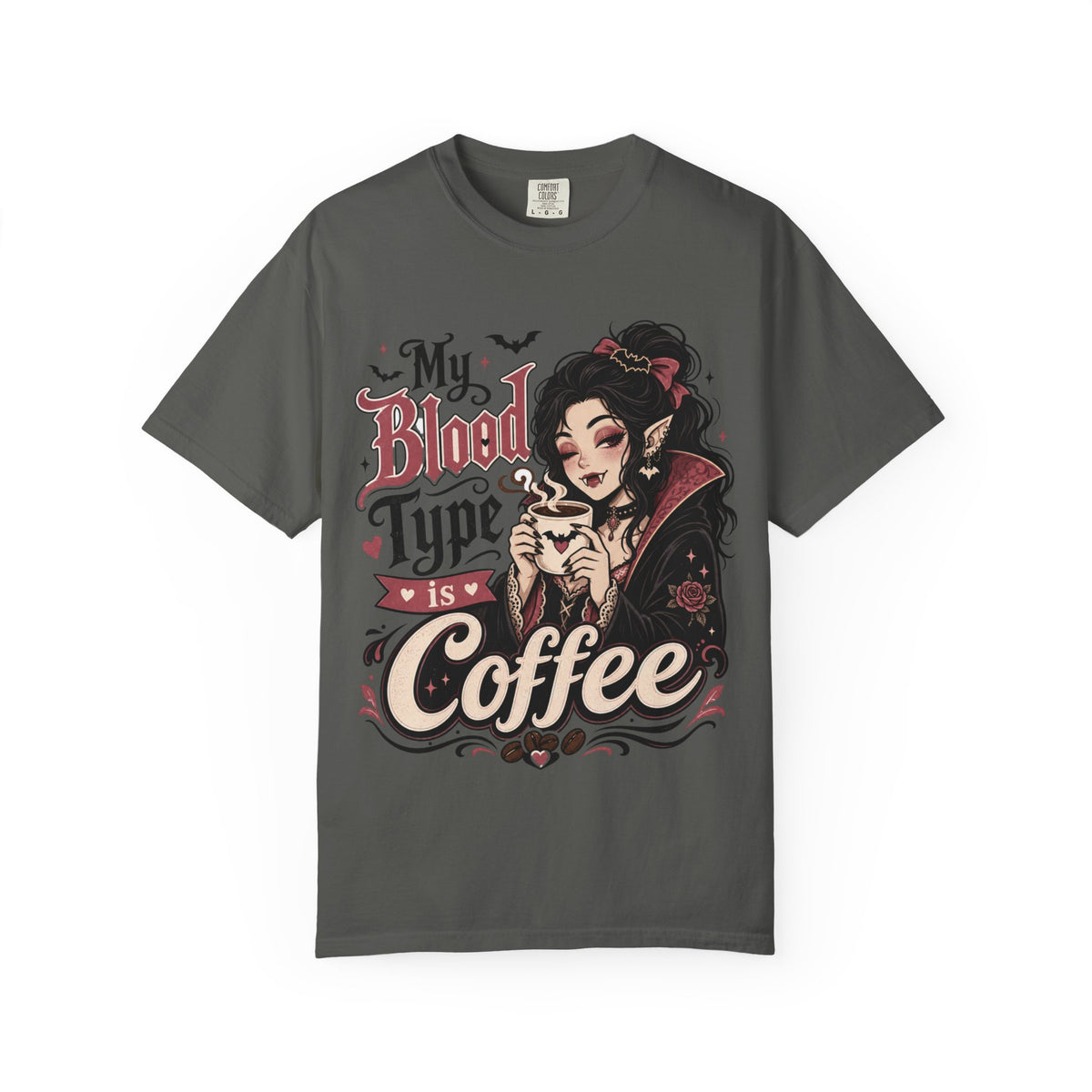 A dark gray short-sleeve crewneck t-shirt featuring a gothic-style graphic print of a vampire woman and the text 'My Blood Type is Coffee' in stylized red and beige lettering.