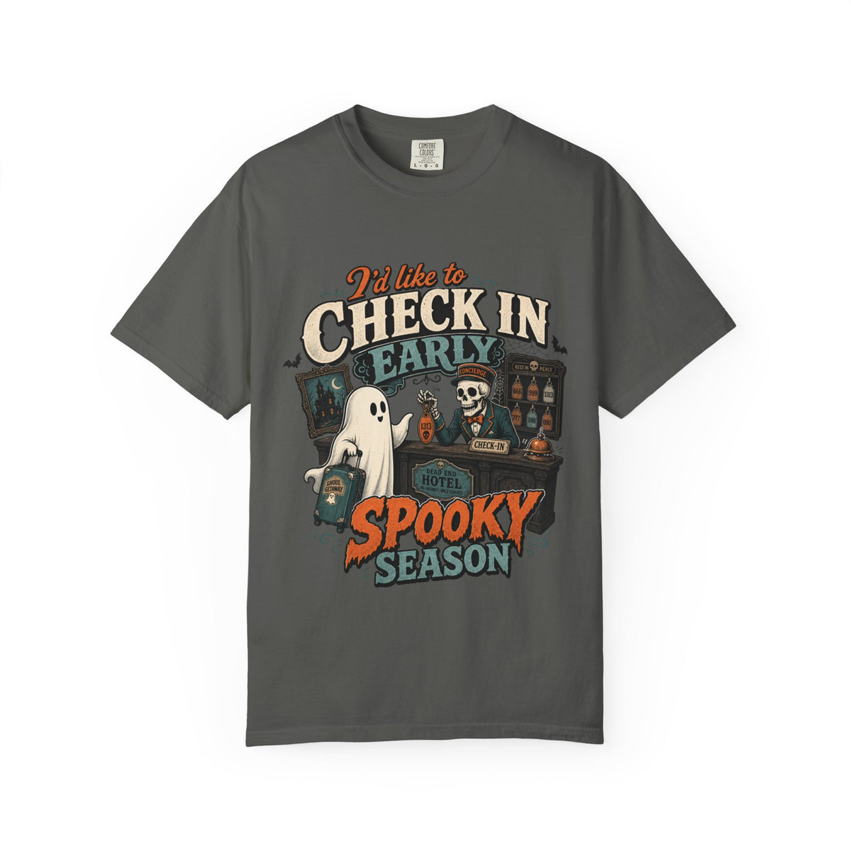 A dark gray short-sleeve crewneck t-shirt featuring a colorful graphic print on the front with the text 'I'd like to CHECK IN EARLY SPOOKY SEASON' and illustrations of a skeleton concierge, a ghost, and a haunted house.