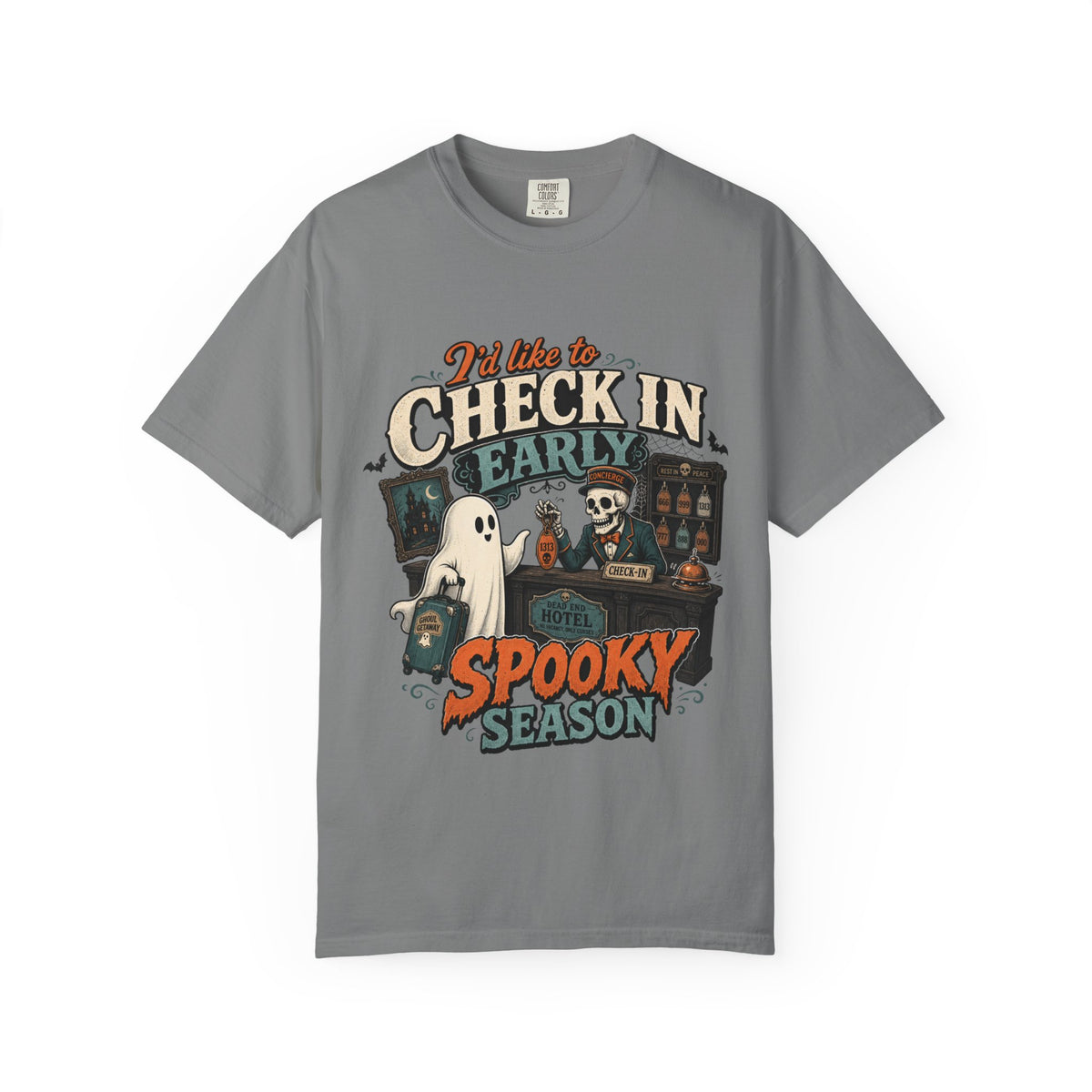 A gray short-sleeve crewneck t-shirt featuring a colorful graphic print on the front with the text 'I'd like to CHECK IN EARLY SPOOKY SEASON' and illustrations of a skeleton concierge, a ghost, and a haunted house.