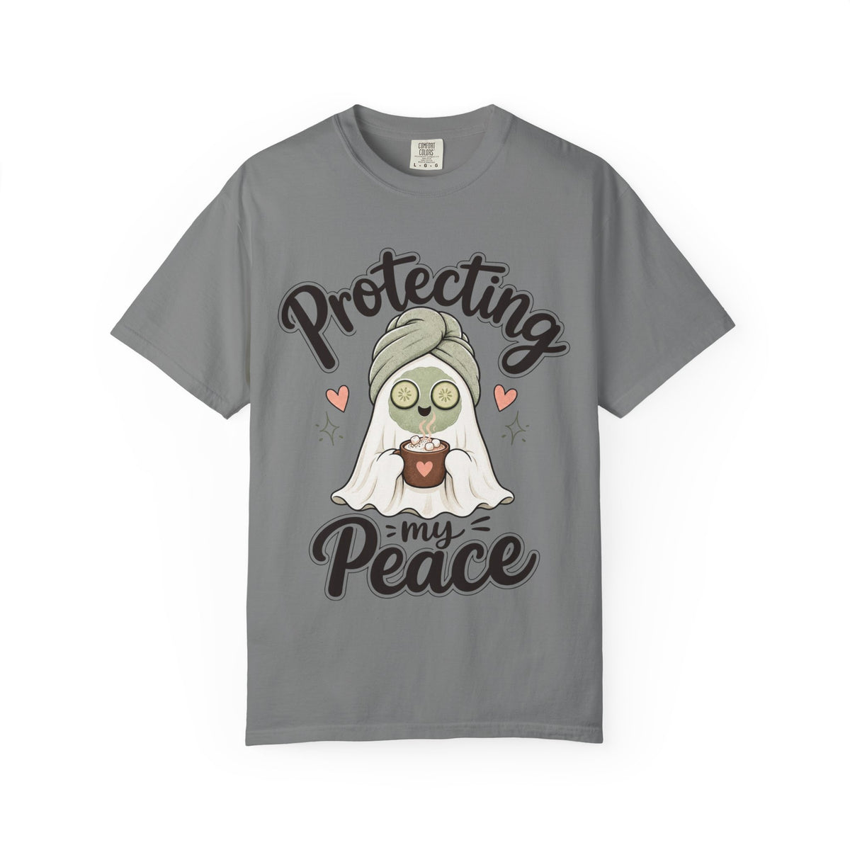 A gray short-sleeve crewneck t-shirt featuring a graphic of a cartoon ghost wearing a green head wrap, spa mask and holding a cup, with the text 'Protecting my Peace' written in black script.
