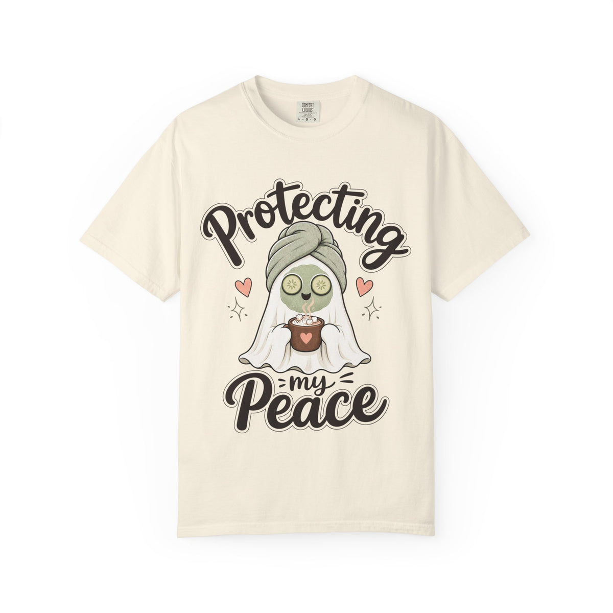 A off-white short-sleeve crewneck t-shirt featuring a graphic of a cartoon ghost wearing a green head wrap, spa mask and holding a cup, with the text 'Protecting my Peace' written in black script.