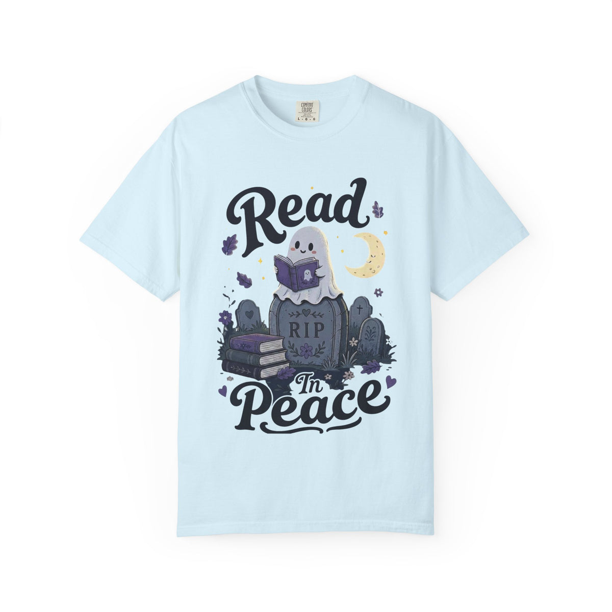A light blue short-sleeve crewneck t-shirt featuring a cute Halloween graphic of a ghost reading a book on top of a tombstone that says 'RIP', with the words 'Read In Peace' written in stylized lettering.