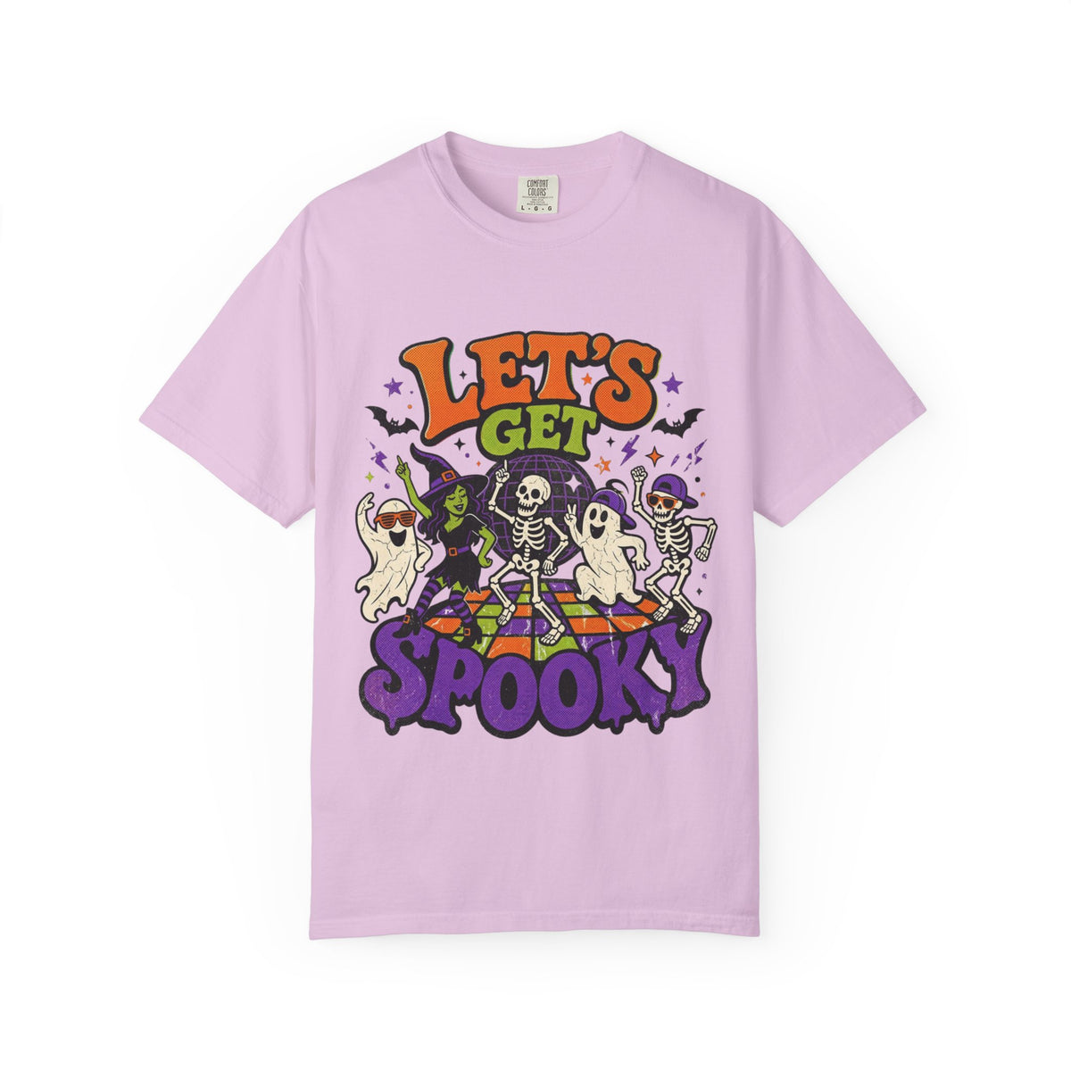 A light purple short-sleeve crewneck t-shirt featuring a colorful Halloween graphic on the front with the text 'LET'S GET SPOOKY' and cartoon ghosts, skeletons, a witch, and bats.