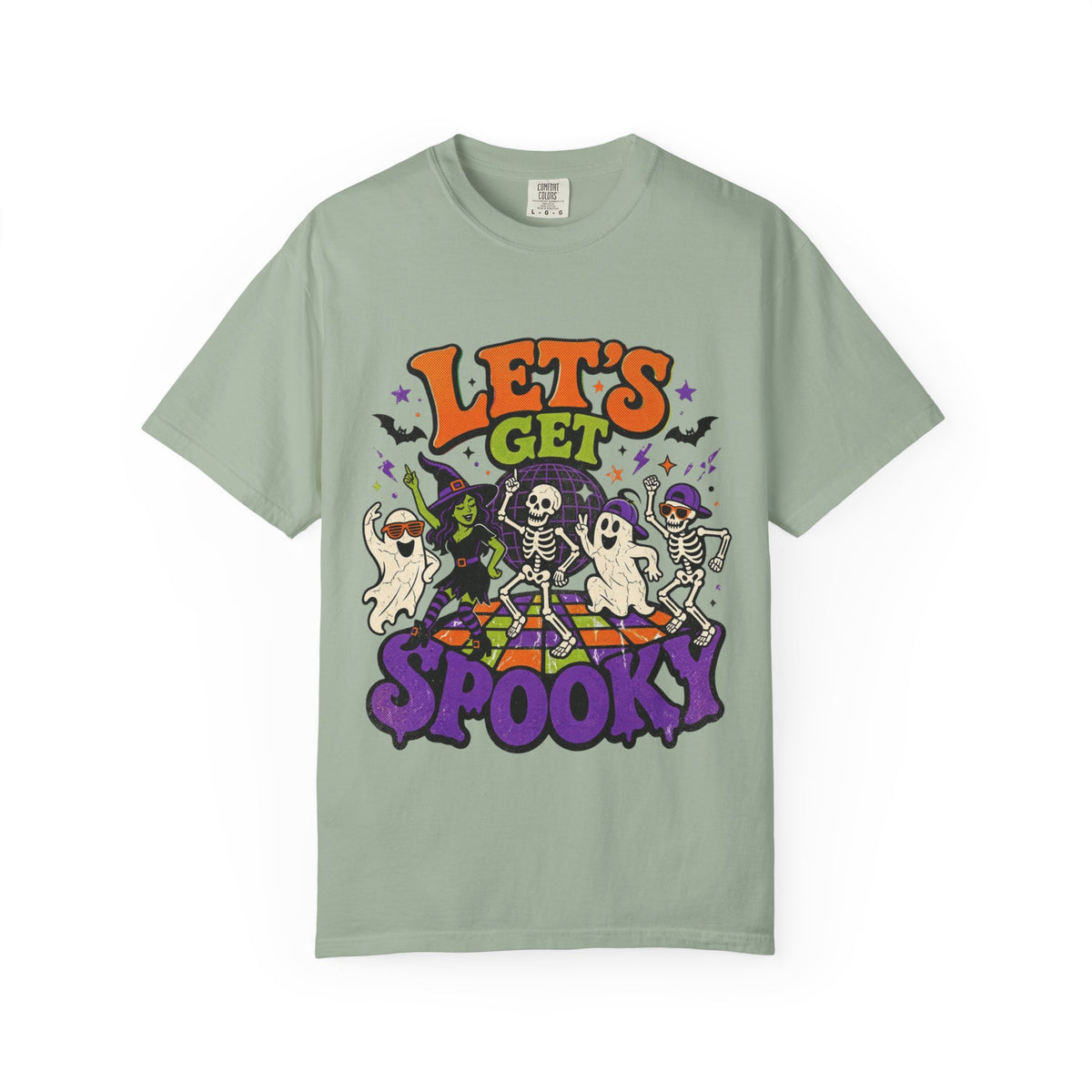 A sage green short-sleeve crewneck t-shirt featuring a colorful Halloween graphic on the front with the text 'LET'S GET SPOOKY' and cartoon ghosts, skeletons, a witch, and bats.