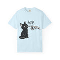 A icy short-sleeve crewneck t-shirt featuring a black graphic of a black cat being tapped by a skeletal hand with the word 'boop' written above, displayed on a clean icy blue background.