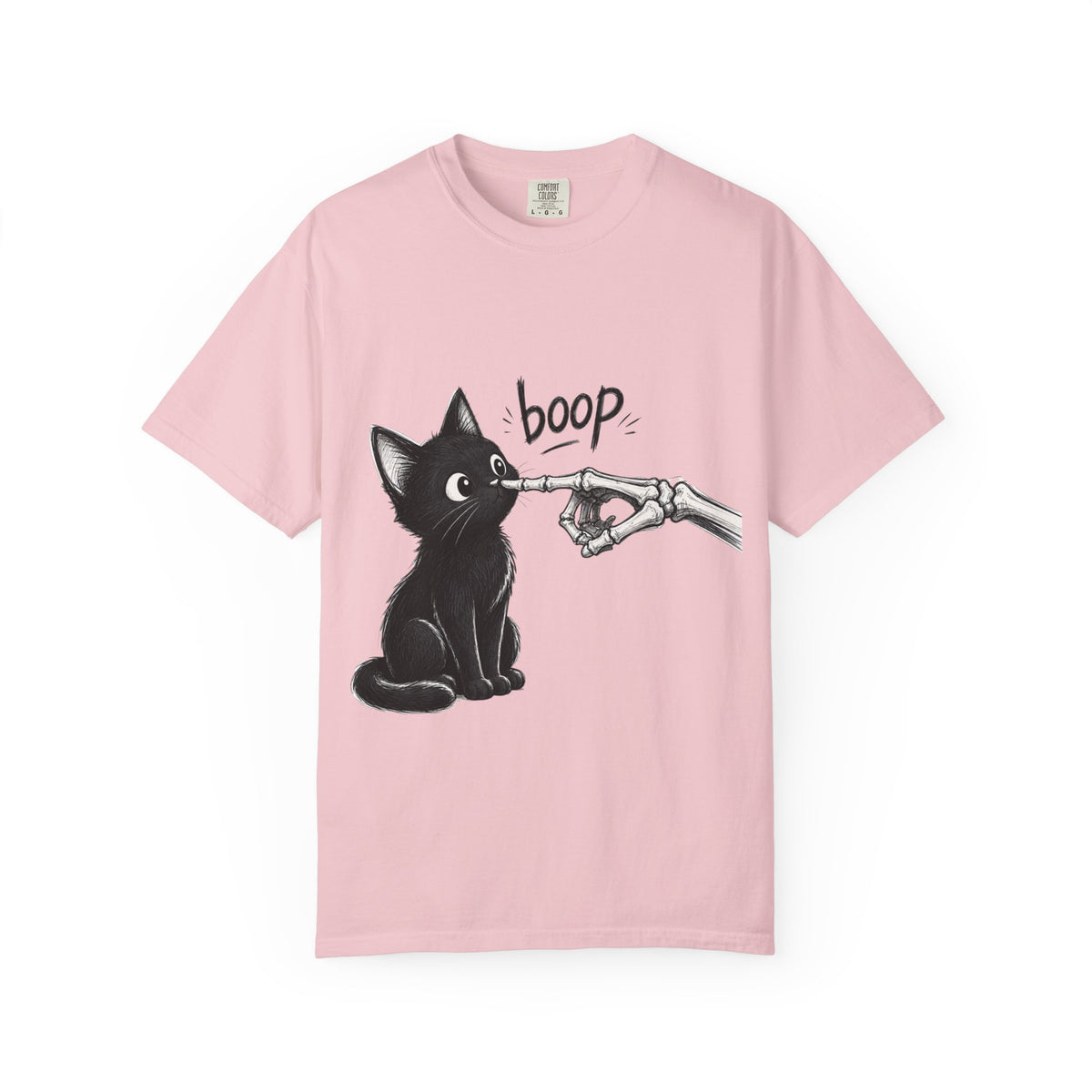 A light pink short-sleeve crewneck t-shirt featuring a black graphic of a black cat being tapped by a skeletal hand with the word 'boop' written above, displayed on a clean light pink background.