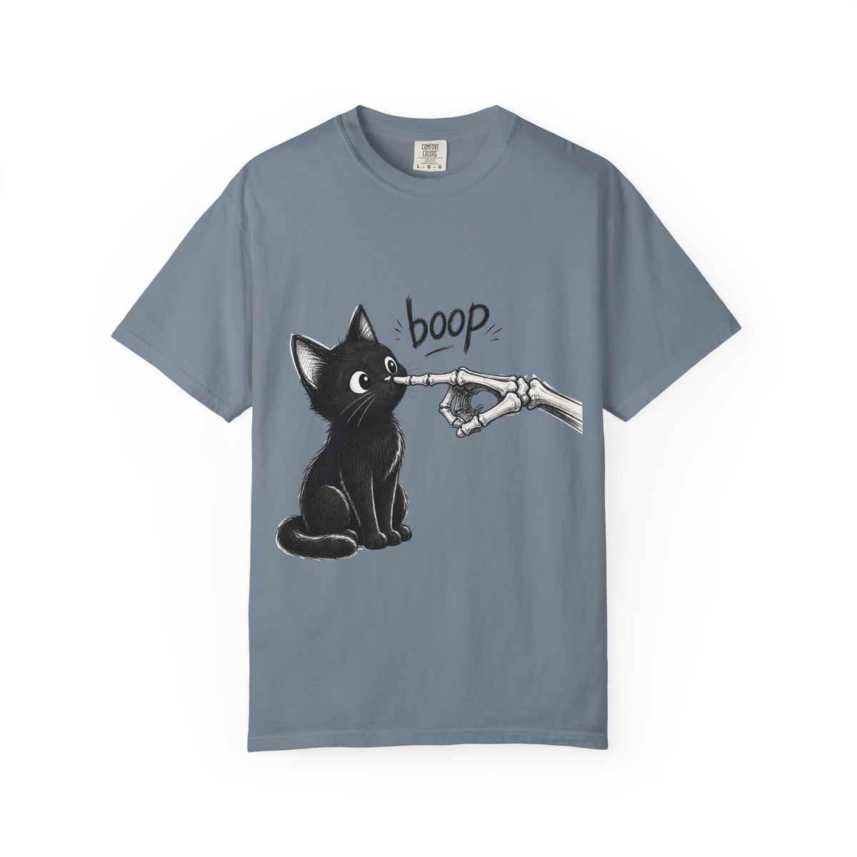 A slate blue short-sleeve crewneck t-shirt featuring a black graphic of a black cat being tapped by a skeletal hand with the word 'boop' written above, displayed on a clean slate blue background.
