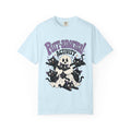 A light blue short-sleeve crewneck t-shirt featuring a cartoon graphic of black cats, a skull, and a ghost with the text 'Purr-anormal! ACTIVITY' in purple and black.