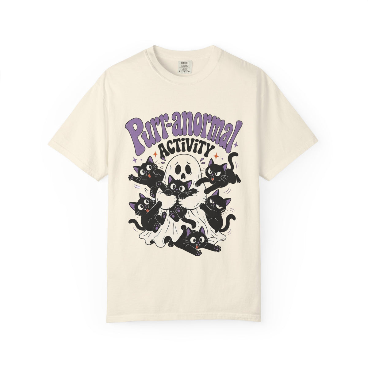 An off-white short-sleeve crewneck t-shirt featuring a cartoon graphic of black cats, a skull, and a ghost with the text 'Purr-anormal! ACTIVITY' in purple and black.