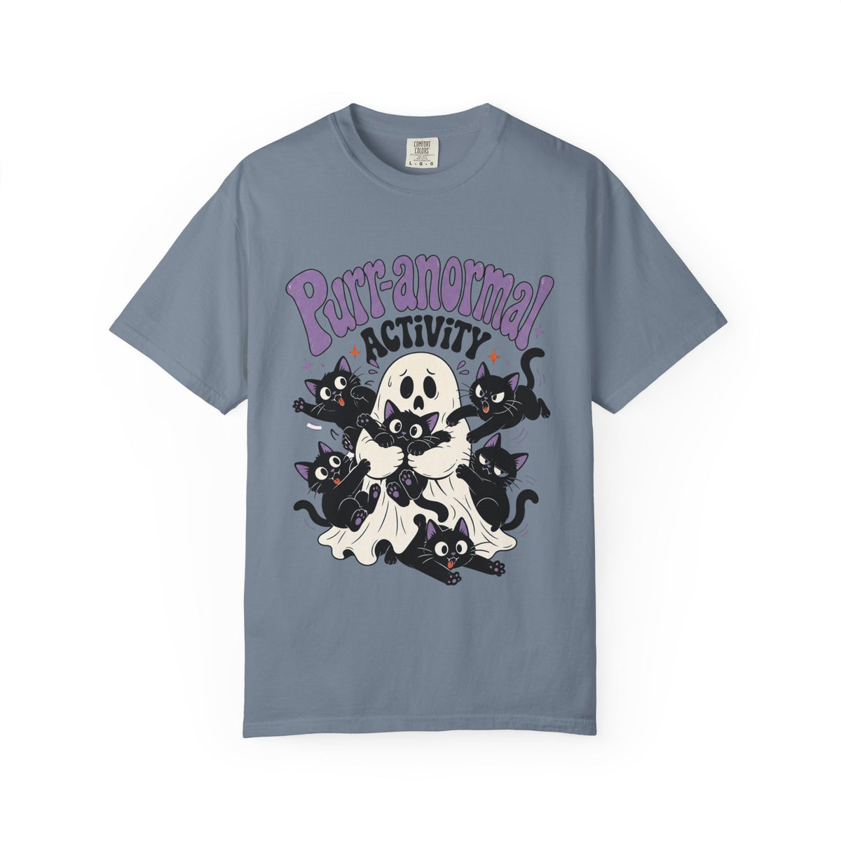 A slate blue short-sleeve crewneck t-shirt featuring a cartoon graphic of black cats, a skull, and a ghost with the text 'Purr-anormal! ACTIVITY' in purple and black.