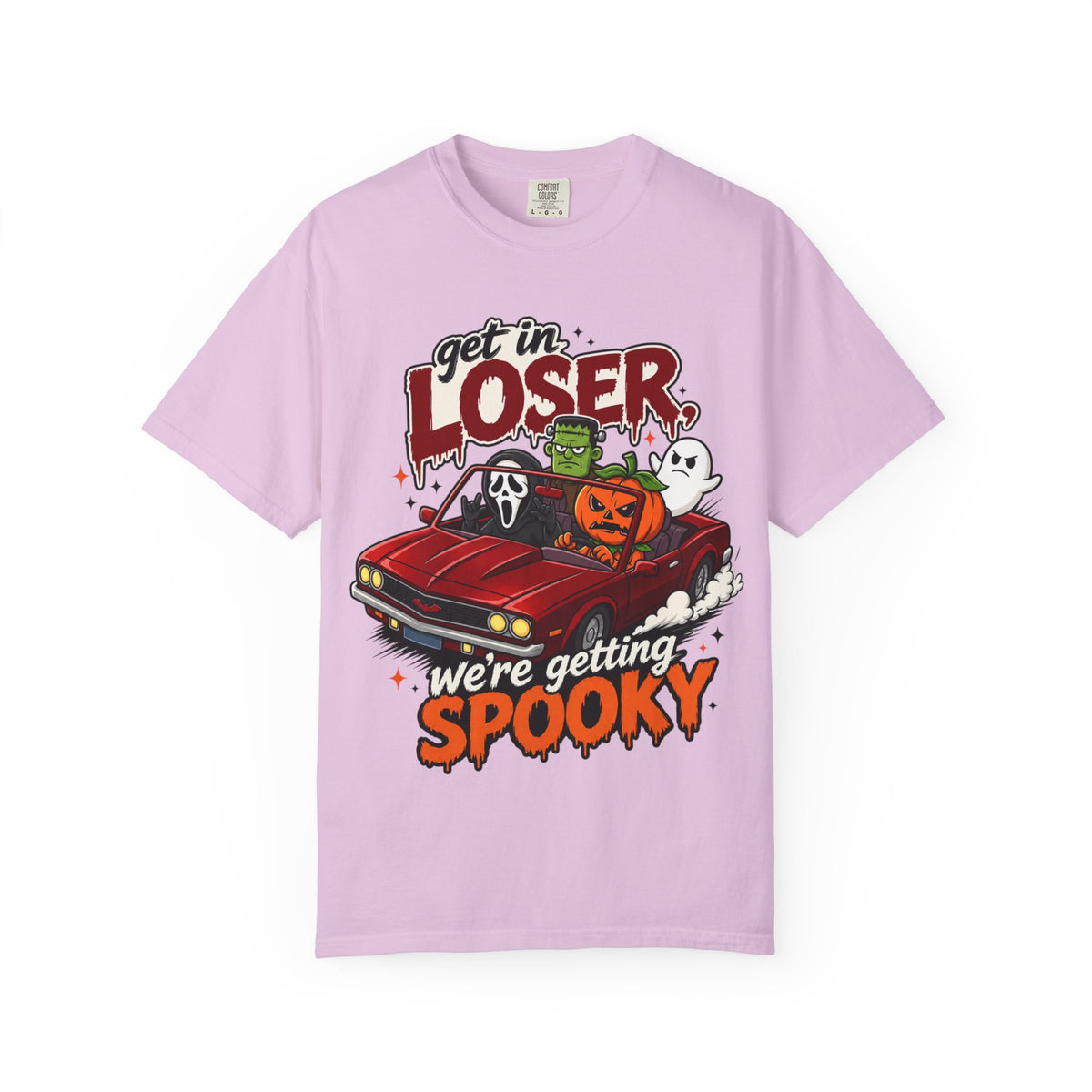 A light purple short-sleeve crewneck t-shirt featuring a colorful Halloween graphic on the front showing a red convertible car with ghosts, a pumpkin, and Frankenstein, with the text 'Get in LOSER, we're getting SPOOKY'.