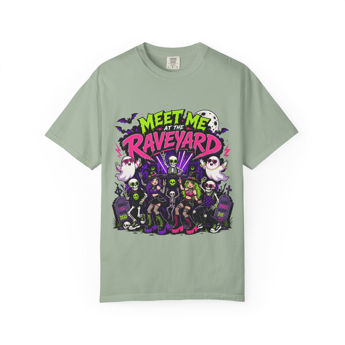 A sage green short-sleeve crewneck t-shirt featuring a colorful graphic print on the front with the text 'MEET ME AT THE RAVEYARD' and a group of cartoon-style gothic characters.