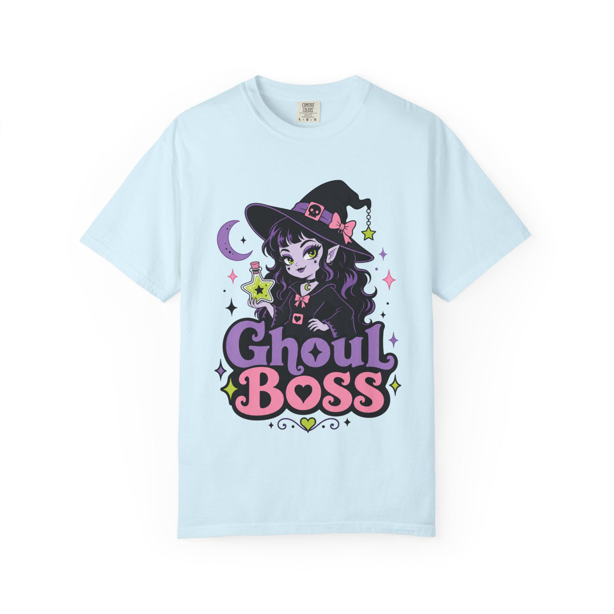 A light blue short-sleeve crewneck t-shirt featuring a colorful graphic of a cute anime-style witch girl with the text 'Ghoul BOSS' in purple and pink.