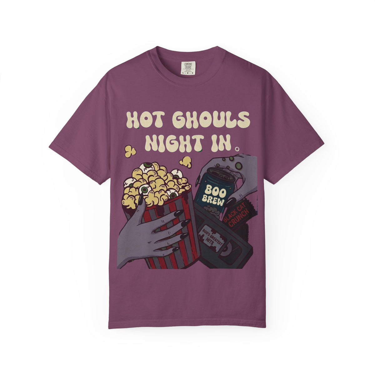 A dark purple crewneck t-shirt featuring a graphic print of hands holding a bucket of popcorn, soda and a cassette tape beneath the text 'HOT GHOULS NIGHT IN'.