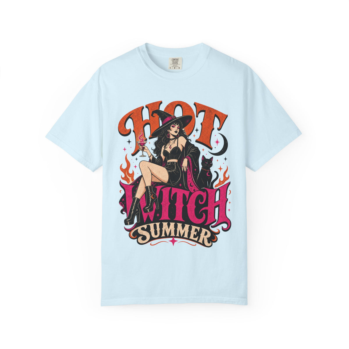 A light blue short-sleeve crewneck t-shirt featuring a colorful graphic print of a witch sitting on a chair with the text 'HOT WITCH SUMMER' in stylized orange and pink lettering.