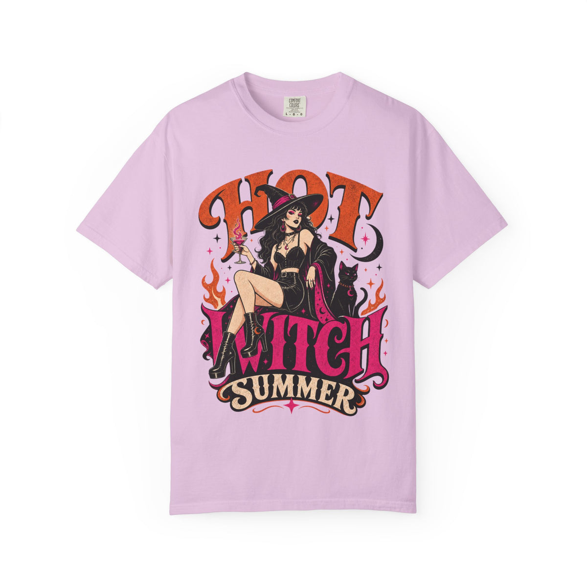 A light purple short-sleeve crewneck t-shirt featuring a colorful graphic print of a witch sitting on a chair with the text 'HOT WITCH SUMMER' in stylized orange and pink lettering.