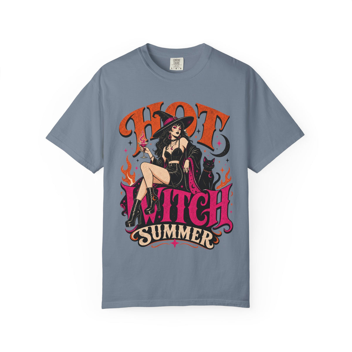 A slate blue short-sleeve crewneck t-shirt featuring a colorful graphic print of a witch sitting on a chair with the text 'HOT WITCH SUMMER' in stylized orange and pink lettering.