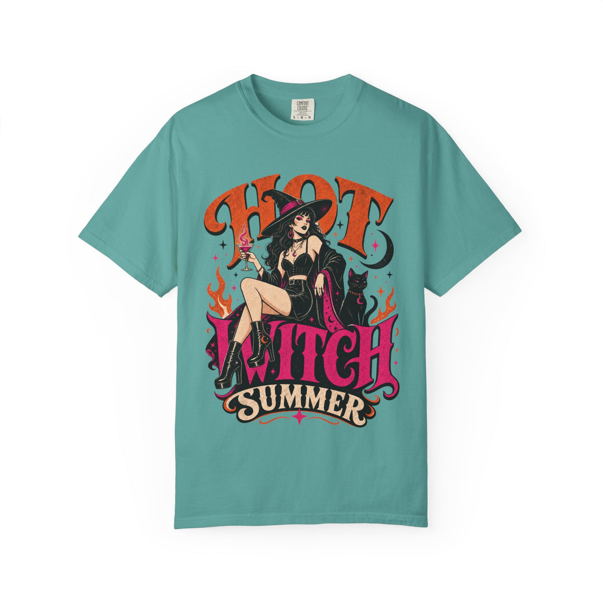 A teal short-sleeve crewneck t-shirt featuring a colorful graphic print of a witch sitting on a chair with the text 'HOT WITCH SUMMER' in stylized orange and pink lettering.