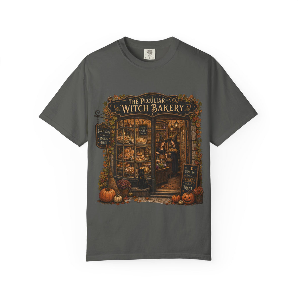 A dark gray short-sleeve crewneck t-shirt featuring a detailed graphic print of 'The Peculiar Witch Bakery' on the front, displayed against a clean white background.