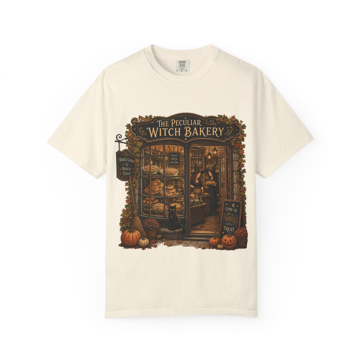 An off-white short-sleeve crewneck t-shirt featuring a detailed graphic print of 'The Peculiar Witch Bakery' on the front, displayed against a clean white background.