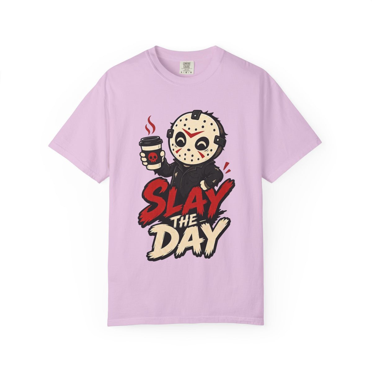 A light pink short-sleeve crewneck t-shirt featuring a graphic print of a cute halloween character holding a coffee cup with the text 'SLAY THE DAY' in red and beige lettering.