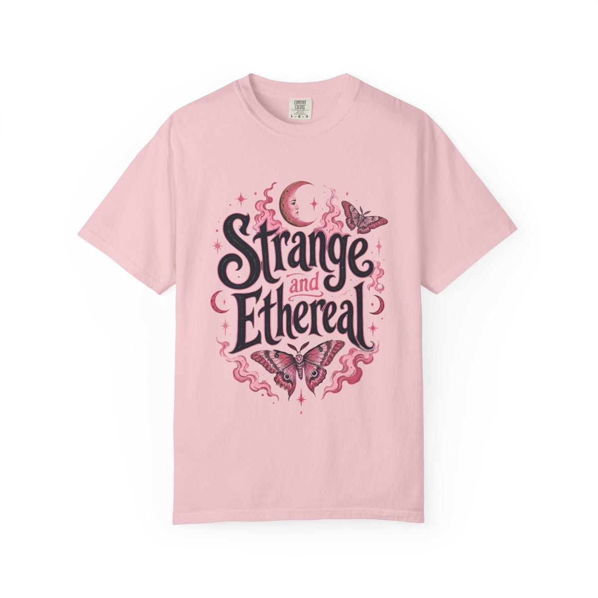 A pink short-sleeve crewneck t-shirt featuring a central graphic with the words 'Strange and Ethereal' in a dark gothic font, surrounded by pink and red butterflies, crescent moons, and sparkles.
