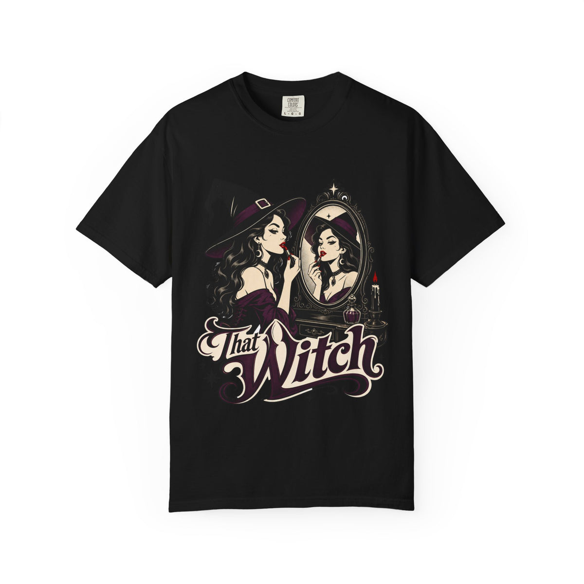 A black short-sleeve crewneck t-shirt featuring a graphic print of a witch applying lipstick in front of a mirror, with the text 'That Witch' written below in a stylized font.