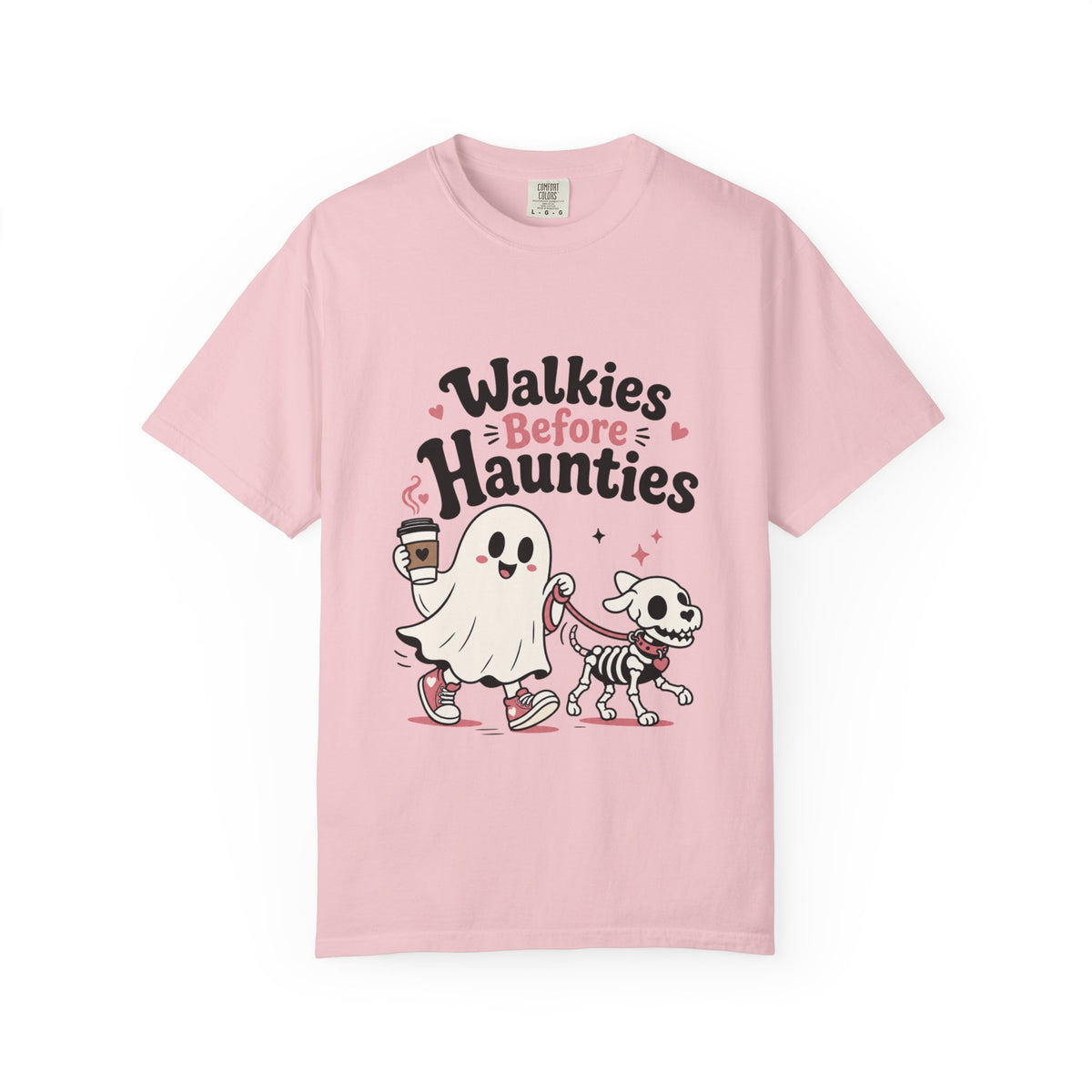 A pink short-sleeve crewneck t-shirt featuring a cute graphic print of a cartoon ghost and a skeleton dog walking together, with the text 'Walkies Before Haunties' above them.