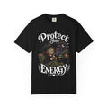 A black short-sleeve crewneck t-shirt featuring a graphic showing a cartoon witch sitting in bed with her cat, both wearing spa face masks, under a window with crescent moon, with the text 'Protect Your Energy' written in a gothic font.