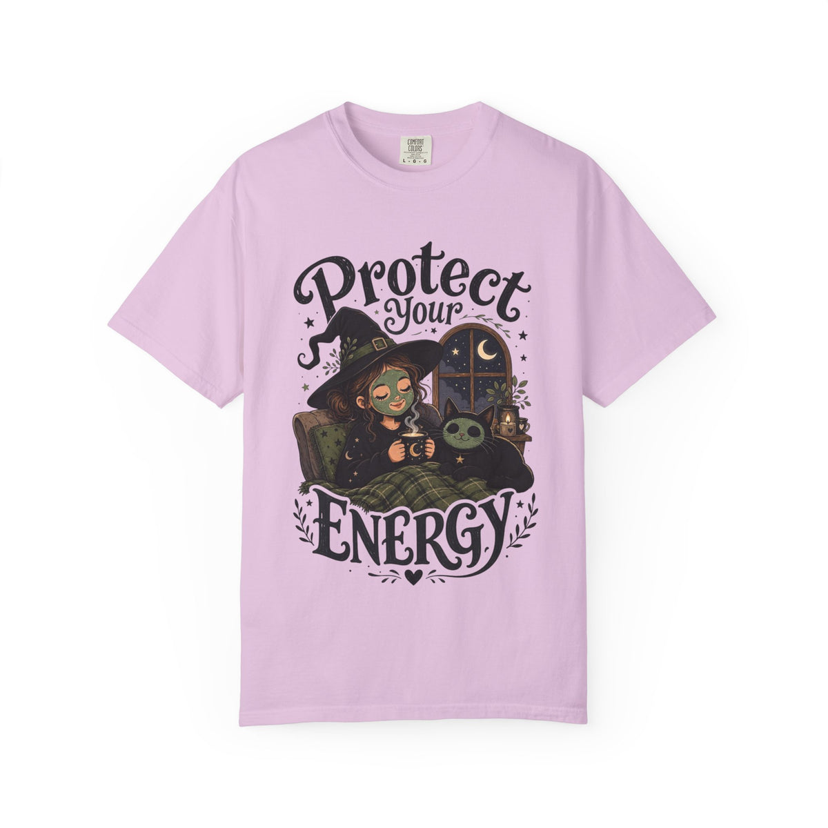 A light purple short-sleeve crewneck t-shirt featuring a graphic showing a cartoon witch sitting in bed with her cat, both wearing spa face masks, under a window with crescent moon, with the text 'Protect Your Energy' written in a gothic font.