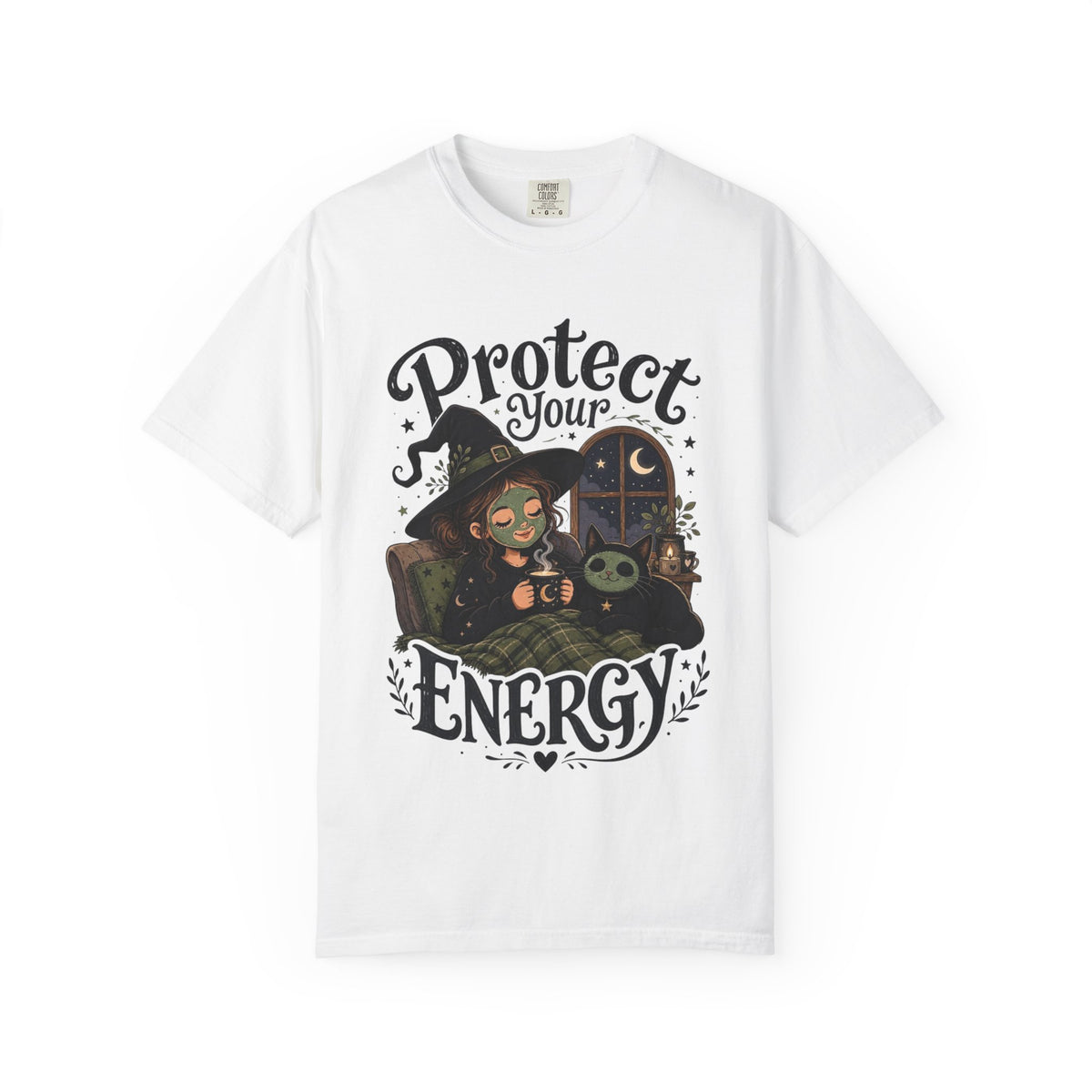 A white short-sleeve crewneck t-shirt featuring a graphic showing a cartoon witch sitting in bed with her cat, both wearing spa face masks, under a window with crescent moon, with the text 'Protect Your Energy' written in a gothic font.